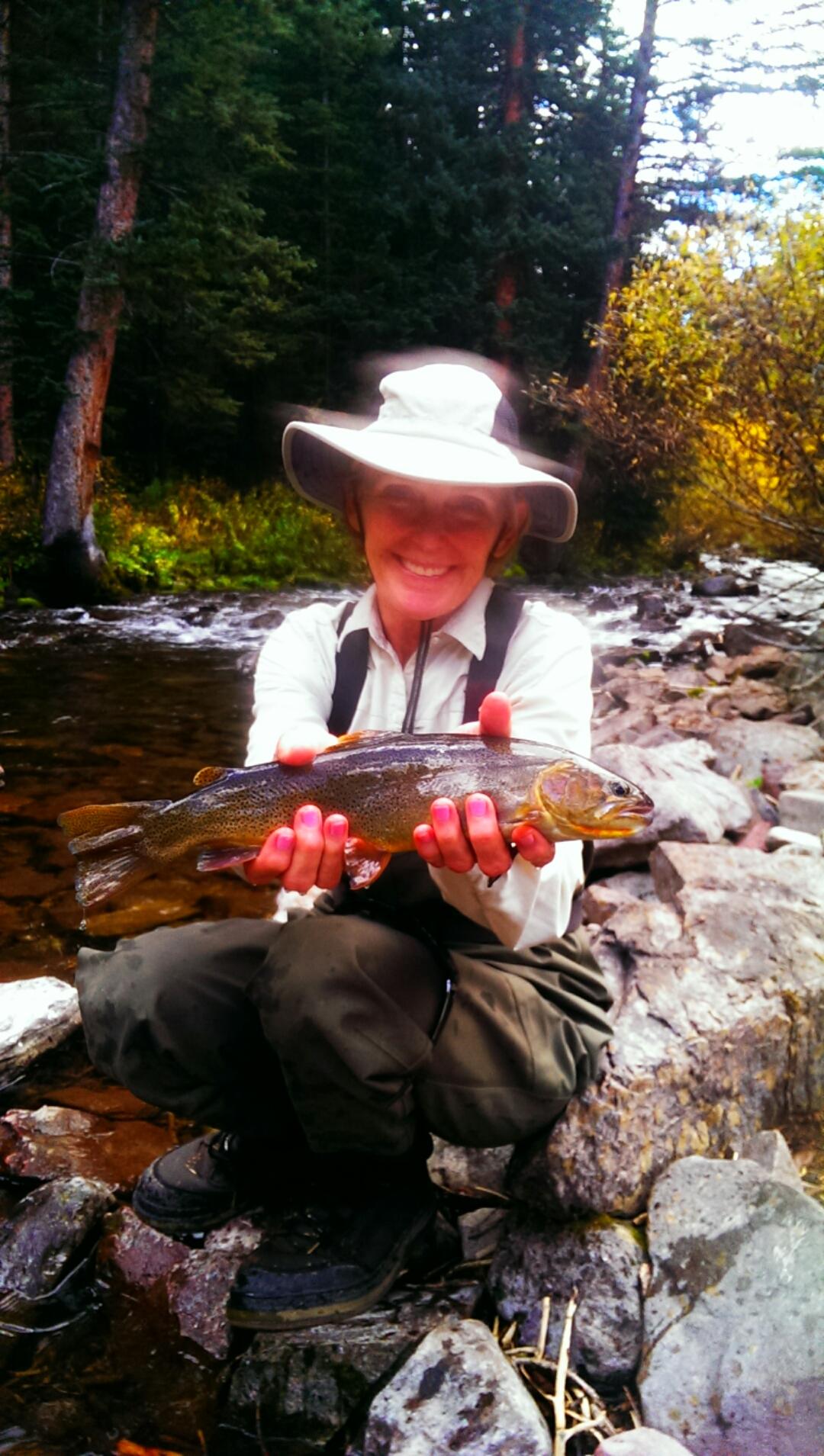 Woman with fish caught in rocky rivers of Colorado