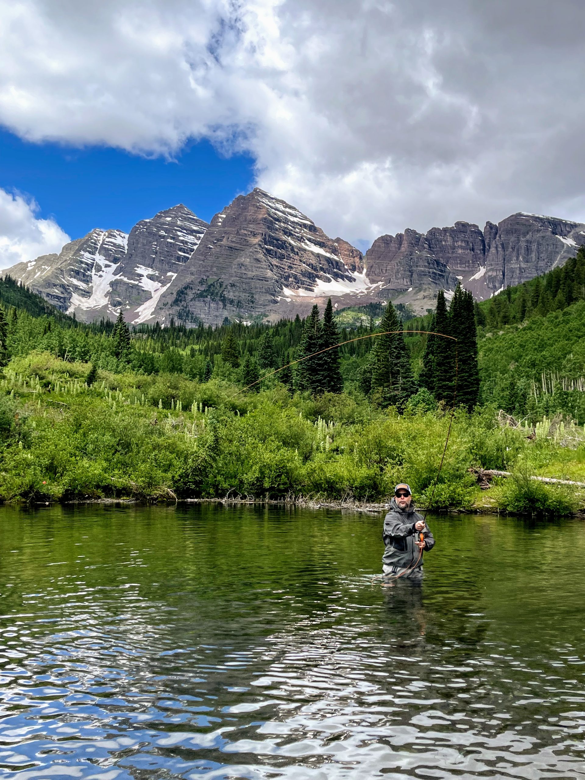 Fly fishing among the greenery and mountain view