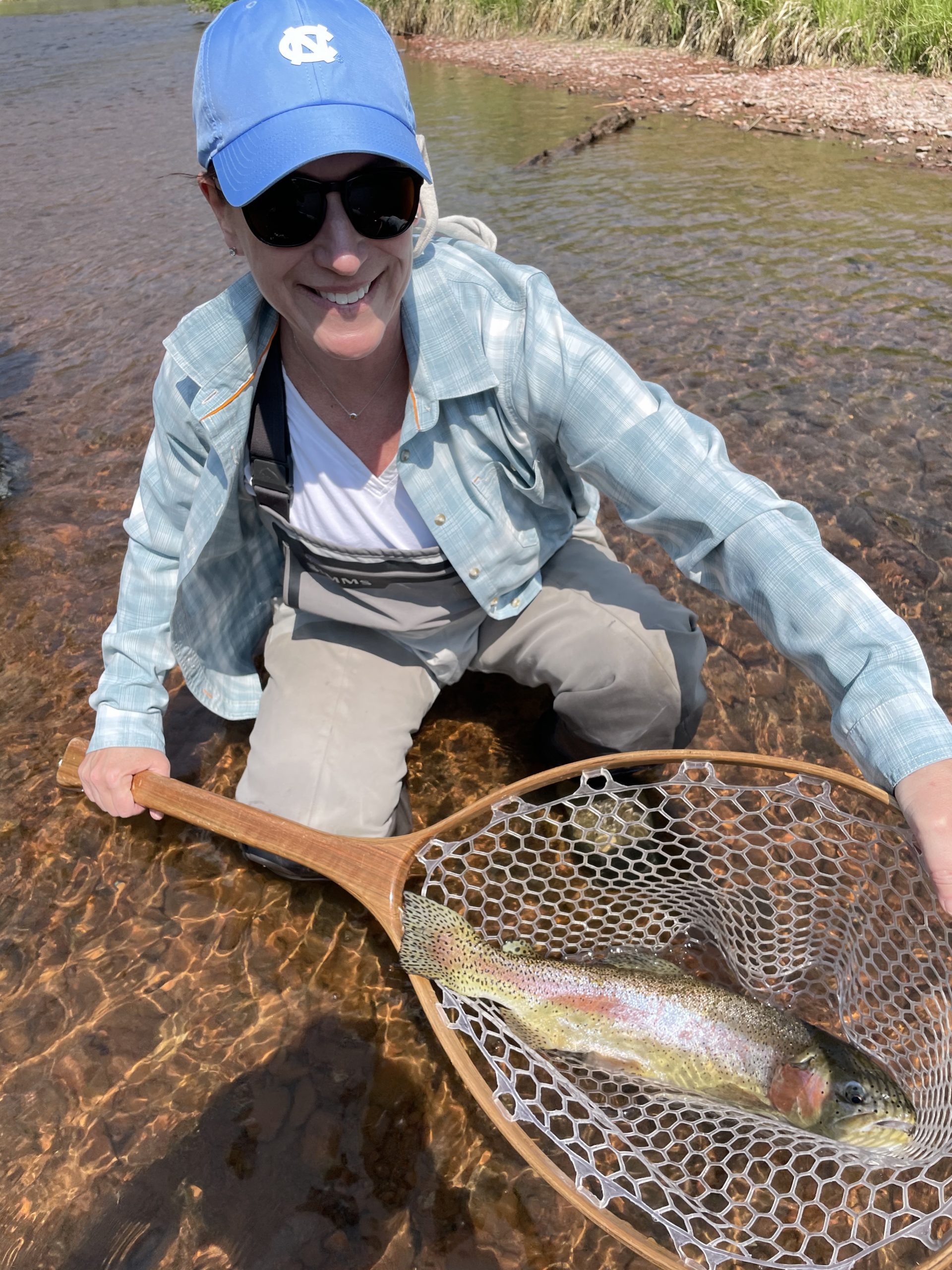 Woman fishing for trout with net