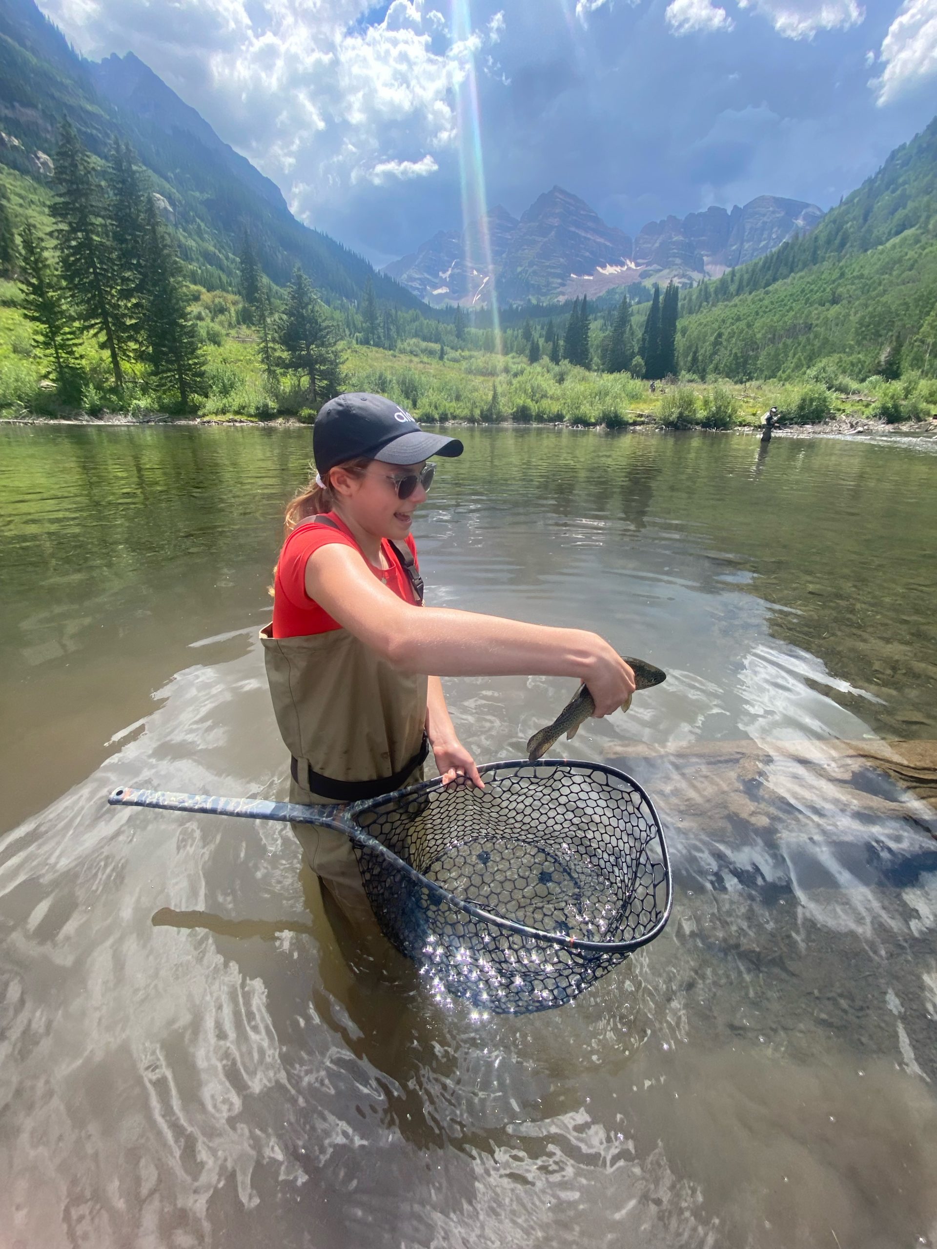 Girl in Colorado river near Aspen with Fish