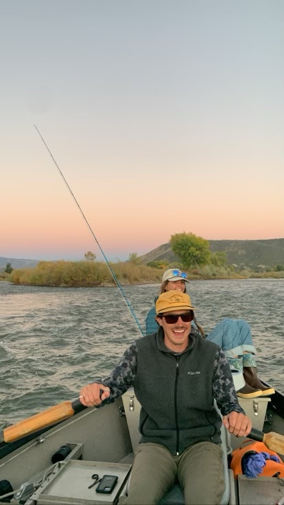 Pierce Klingbiel fishing for trout on river with boat